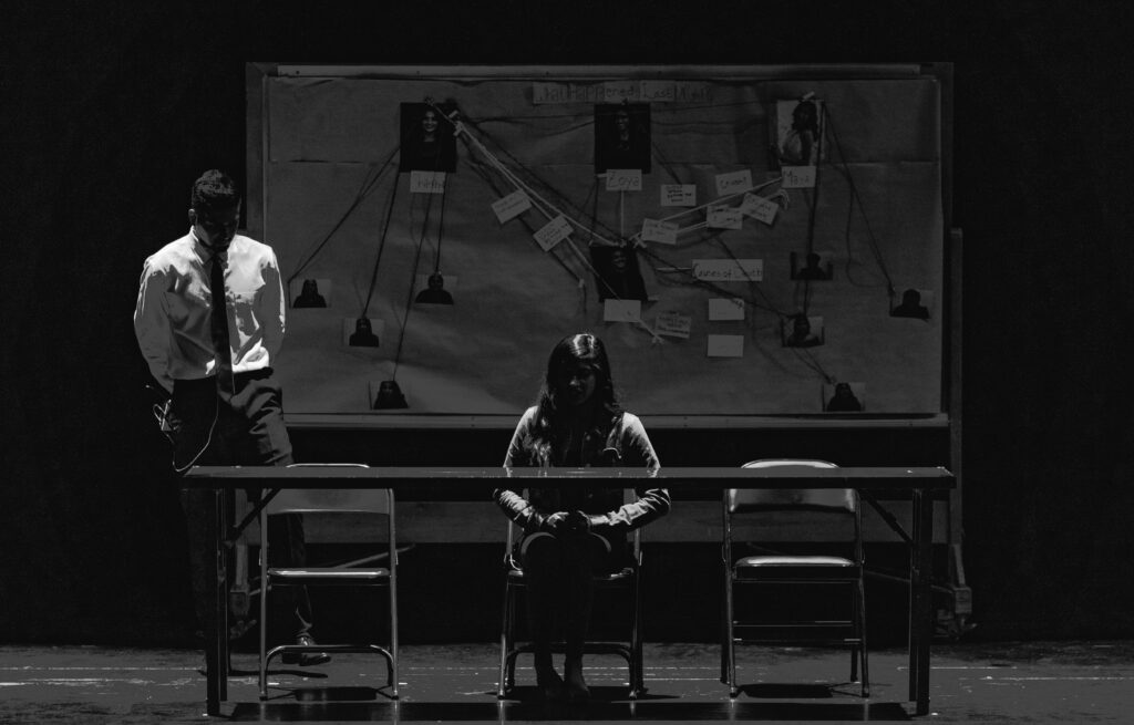 pexels-photo-2157191-2157191 Black and white scene depicting a tense interrogation with suspect and investigator.